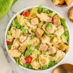 Tossed tortellini Caesar salad with romaine lettuce, parmesan, croutons, and cherry tomatoes.