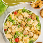 Tortellini Caesar Salad with romaine, cherry tomatoes, croutons, and parmesan, labeled with website name acupofcream.com.